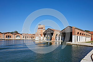 Venetian Arsenal with docks, canal and industrial building in Venice, Italy