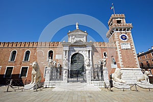 Venetian Arsenal entrance with white statues in Venice, Italy