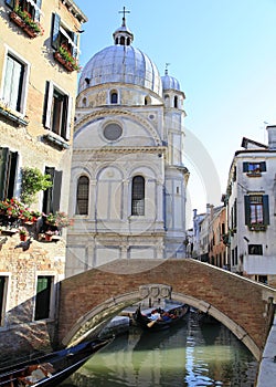 Venetian canal with the church of Santa Maria dei Miracoli in the background photo