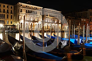 Venetian Canal at night with Gondolas. Sightseeing in Venice, Italy