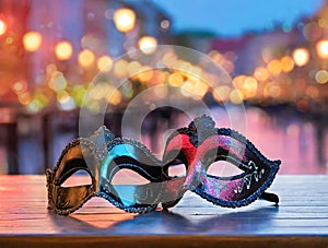 Venetian carnival masks in front of canal in Venice at night