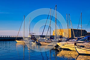 Venetian castle and fishing boats in bay of Heraklion, Crete, Greece