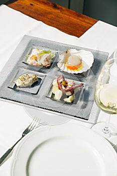 Venetian Cicchetti with shrimps, scallop, octopus and potatoes, and sea bass