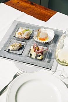 Venetian Cicchetti with shrimps, scallop, octopus and potatoes, and sea bass photo