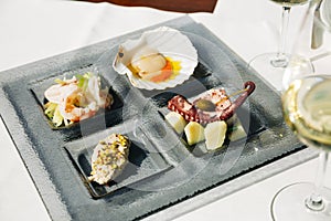 Venetian Cicchetti with shrimps, scallop, octopus and potatoes, and sea bass photo