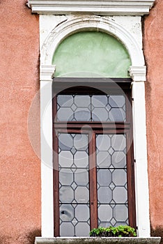 Venetian craftsmanship on display with window on historic buildings in Venice, Italy.