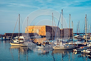 Venetian Fort in Heraklion and moored fishing boats, Crete Island, Greece