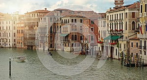 Venetian gondola and boats in big canal waters of Venice Italy