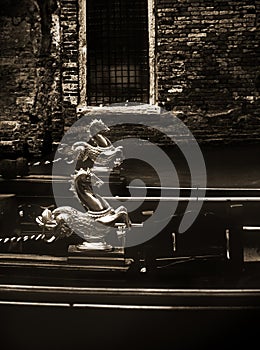 Venetian gondola detail against ancient house at waterway