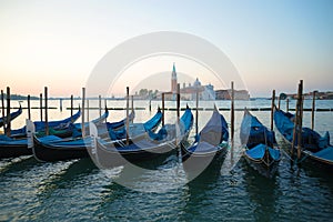 Venetian gondolas in the background of the Cathedral of San Giorgio Maggiore in the early morning. Venice, Italy