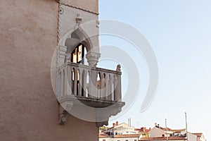 Venetian house. Corner balcony with a stone balustrade, Tartini Square, Piran