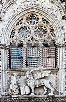 Venetian lion and Doge on a cathedral building on San Marco square in Venice, Italy. Venice`s symbol the winged lion