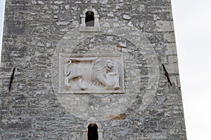 the Venetian lion on the wall of the clock tower from Umag