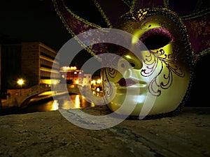 Venetian mask and night canal view