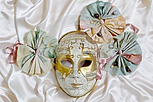 Venetian mask Volto and textile rosettes with ribbons photo