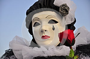 Venetian Pierrot female mask with red rose photo