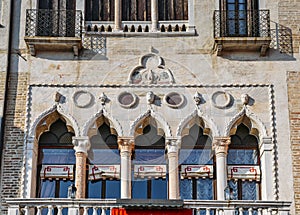 Venetian style windows on building facade.