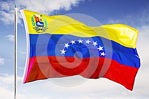 Venezuela national flag waving under blue sky