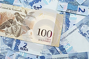 A Venezuelan Bolivares bank note with Brazilian two reais bank notes photo