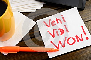 Veni vidi won writing on white napkin