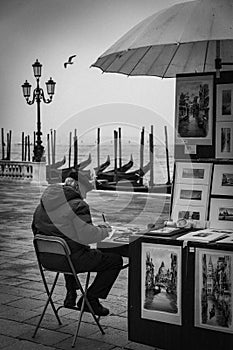 An ambulant painter selling his work on the streets of Venice city