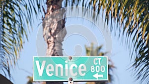 Venice beach street road sign, California city, USA. Tourist resort, palm trees