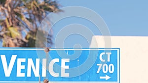 Venice beach street road sign, California city, USA. Tourist resort, palm trees