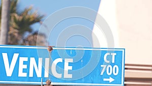 Venice beach street road sign, California city, USA. Tourist resort, palm trees