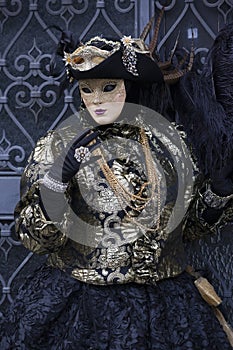 Venice Carnival Figures in black and gold costume and Venice Italy