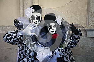 Venice Carnival Figures in black and white costumes and Venetian masks Venice Italy