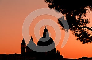 Venice cathedral dome silhouette at sunset. Amazing burning sky
