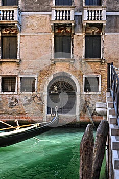 Venice channel with a gondolier`s boat passing