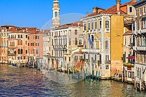 Venice cityscape, narrow water canal, campanile church on background and traditional buildings. Italy, Europe.