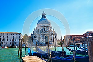 Venice cityscape view on Santa Maria della Salute basilica with gondolas on the Grand canal