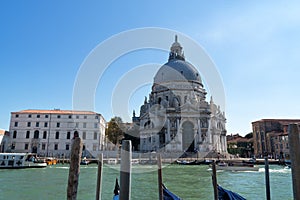 Venice cityscape view on Santa Maria della Salute basilica with gondolas on the Grand canal