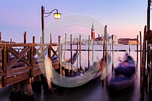 Venice with famous gondolas in lagoon at sunrise