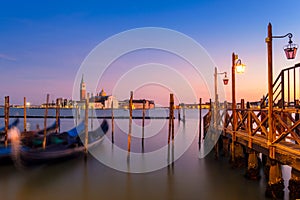 Venice with famous gondolas in lagoon at sunrise