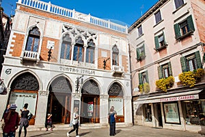 Tourists and locals walking around the beautiful streets of Venice in a sunny early spring day