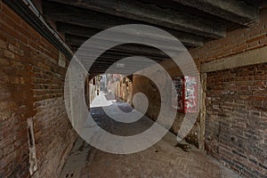 VENICE, ITALY - August 03, 2019: Narrow pedestrian streets of Venice bitween the channels. Some quiet places almost without people