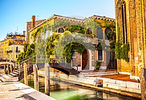 VENICE, ITALY - AUGUST 21, 2016: View on the cityscape and lovely bridge on the canal of Venice on August 21, 2016 in Venice