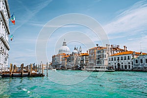 Venice, Italy. Beautiful view of turquoise-green colored Grand Canal and Basilica Santa Maria della Salute against blue