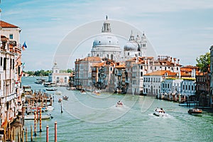 Venice, Italy. Daily boat and tourist hectic on Grand Canal and Basilica Santa Maria della Salute