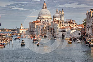 Venice, Italy: Boats sailing in the Grand canal and Basilica Santa Maria della salute against dramatic clouds