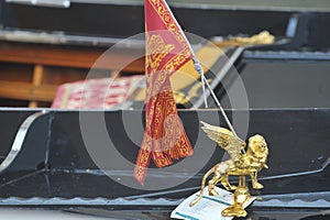 Venice, Italy Closeup of a Venetian gondola in the rain with flag and coat of arms of the city of Venice, the