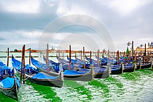 Venice, Italy. Empty docked gondolas/ gondole/ gondola boats floating on the river canal