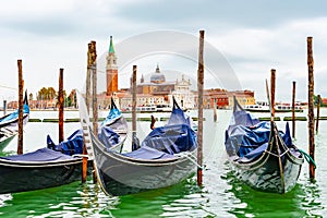 Venice, Italy. Empty Gondolas/ Gondole docked by lagoon mooring poles.