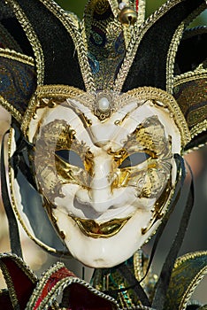 Close-up of typical Venetian carnival masks with musical motifs at a street shop in Venice, Italy.