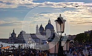 Venice, Italy: Gondola boats and street lights against the Basilica of St Mary of Health or Basilica di Santa