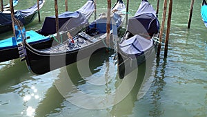 Venice, Italy - gondolas in the Grand Canal near the Rialto Bridge and between the canals of the lagoon city