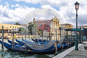 Venice, Italy. Gondolas moored on the Grand Canal and Church of Scalzi